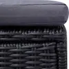 A close-up view of the texture of a dark gray cushion on a black rattan-style base. Produktbild-Vorschau