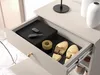 A drawer of a shoe cabinet is open, showing various items inside. Náhľad obrázku produktu