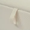 Close-up view of a fabric strap on a striped surface. Anteprima dell’immagine prodotto