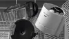 A coffee maker carafe and lid are placed in a dishwasher rack. Náhled obrázku produktu