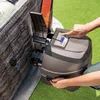 A person is interacting with the control panel of an inflatable hot tub pump unit. Voir les images du produit