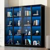 A black glass display cabinet with blue LED lighting, showcasing various decorative items and books on its shelves. Voir les images du produit