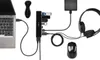 A laptop connected to a USB hub with various peripherals attached, including flash drives, headphones, a hard drive, and a mouse. Produktbild-Vorschau