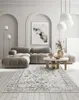A living room with a sofa, coffee table, rug, and artwork. Produktbild-Vorschau