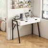 A white desk with black legs is set up in a room with wooden floors and shelves on the wall. Náhled obrázku produktu