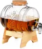 A glass beverage dispenser with a spigot, filled with a brown liquid, resting on a wooden stand. Produktbild-Vorschau