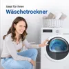 A woman is posing next to a washing machine with a basket of towels on top. Produktbild-Vorschau
