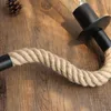 Close-up of a rope-wrapped lamp on a wooden surface. Náhľad obrázku produktu