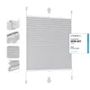 A light gray pleated blind (Rollo) is shown against a white background. Several close-up detail shots of the mounting hardware and the pleats are displayed on the left side of the image. A review badge from 'Vergleich.org' is present on the right side. Produktbild-Vorschau