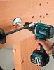 A person is using a Makita drill to bore a large hole into a wooden beam. Produktbild-Vorschau