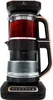 A product shot of a black and copper tea maker with red tea in the upper chamber and water in the lower chamber. Produktbild-Vorschau