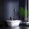 A modern bathroom with a freestanding bathtub, a shower fixture, and a plant. Náhľad obrázku produktu