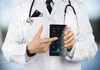 A doctor in a white coat is holding a device with a keypad and pointing at it. Produktbild-Vorschau