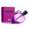 A purple heart-shaped perfume bottle and its matching box are displayed against a white background. Produktbild-Vorschau