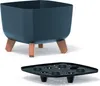A dark blue square planter with wooden legs, shown above a black drainage tray. Produktbild-Vorschau