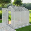 A greenhouse with plants inside, set in a garden. Produktbild-Vorschau