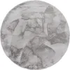 A round, gray rug with a soft, shaggy texture. Produktbild-Vorschau
