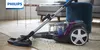 A Philips vacuum cleaner is shown on a rug in a living room. Produktbild-Vorschau