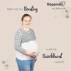 A pregnant woman is wearing a striped shirt and a white belly band, smiling at the camera. The background is a light beige color with dandelion graphics and text. Produktbild-Vorschau