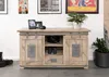 A wooden sideboard with sliding doors, decorated with framed pictures and plants. Voir les images du produit