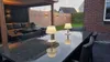 Outdoor patio area with furniture and table lamps. Produktbild-Vorschau