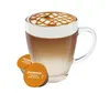 A Starbucks Caramel Macchiato coffee drink in a glass mug with two coffee capsules in front. Produktbild-Vorschau
