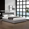 A modern bedroom with a gray upholstered bed frame and headboard, set against a marble-patterned wall and a large window with a grid pattern. Náhled obrázku produktu