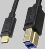 A close-up shot of two USB connectors on a black cable against a plain gray background. Náhled obrázku produktu