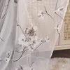 A close-up view of a sheer curtain with a floral pattern. Produktbild-Vorschau