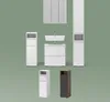 A collection of bathroom furniture, including a sink, vanity, and storage cabinets, arranged against a plain green background. Produktbild-Vorschau