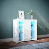 A white cabinet with glass shelves and blue LED lighting is placed in a room with a teal wall and wooden floor. Anteprima dell’immagine prodotto