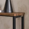 A close-up view of a wooden tabletop with a black lamp and a metal frame. Podgląd zdjęcia produktu