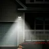 A solar-powered motion-sensing light illuminates a garage door and porch area at night. Voir les images du produit
