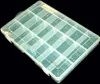 A transparent plastic organizer box with multiple compartments, shown against a black background. Produktbild-Vorschau