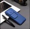 A blue phone case with a sliding camera cover is placed on a laptop keyboard. Produktbild-Vorschau