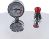 A close-up of a pressure cooker lid with a pressure gauge and a safety valve. Podgląd zdjęcia produktu