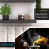 A kitchen scene showing storage jars on a shelf and someone pouring pasta into a pot. Náhled obrázku produktu