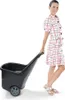 A woman is pulling a garden cart. Podgląd zdjęcia produktu
