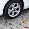 A car tire with snow chains installed on a paved surface. Produktbild-Vorschau