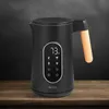 A black electric kettle with a digital display and a wooden handle is shown on a wooden surface against a dark background. Náhľad obrázku produktu