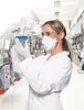 A scientist in a lab coat, safety glasses, and a respirator mask holds up a flask with blue liquid. Produktbild-Vorschau