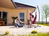 A couple relaxing on a patio with a hammock chair. Anteprima dell’immagine prodotto