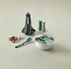 A collection of kitchen utensils and accessories arranged on a light gray surface. Produktbild-Vorschau