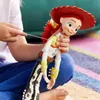 A child's hands are holding a Jessie doll from Toy Story, with a string attached to the doll's back. Podgląd zdjęcia produktu