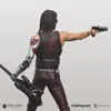 A figure of a character from Cyberpunk 2077, holding a guitar and a gun. Náhled obrázku produktu