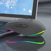 A black wireless mouse with RGB lighting is placed on a laptop keyboard, with the laptop screen showing a winter scene. Náhled obrázku produktu