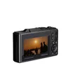 The back of a black digital camera is shown against a white background. The camera's screen displays a sunset scene with silhouetted people. Produktbild-Vorschau