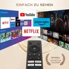 A remote control is shown in the foreground, with various streaming service logos and TV screens in the background, suggesting a media device. Produktbild-Vorschau