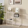 A white console table with three shelves is shown in a room setting, next to a window with a plant. Náhľad obrázku produktu