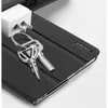 A close-up shot of a black tablet case with keys attached to a loop on the case. Produktbild-Vorschau